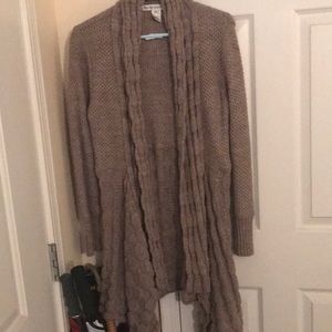 Cable knitted, knee length sweater.